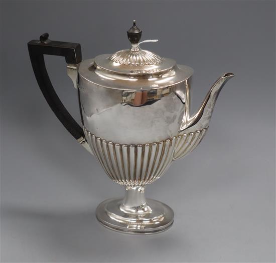 A Victorian demi fluted silver pedestal coffee pot by Edward Hutton, London, 1884, gross 25.5oz.